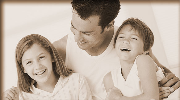 smiling father and daughters